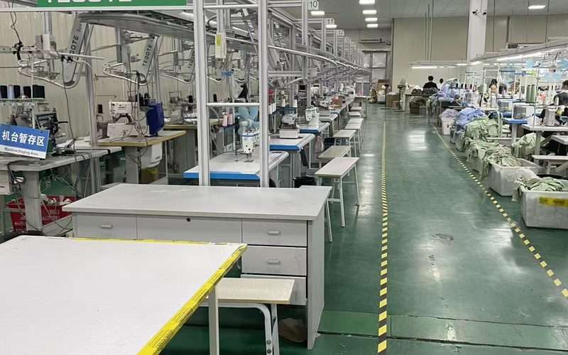 Modern sewing line at YucaiFJ - swimwear sewing technicians working on small-batch orders